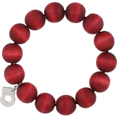 The classic, hand-dyed Pohjola bracelet is made of wooden beads and adorned with a silvery Aarikka logo. Ø 5.5 cm, flexible....