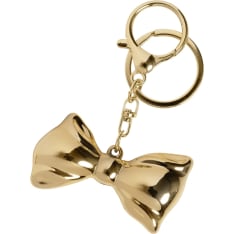 Cailap bow tie gold coloured bag decoration